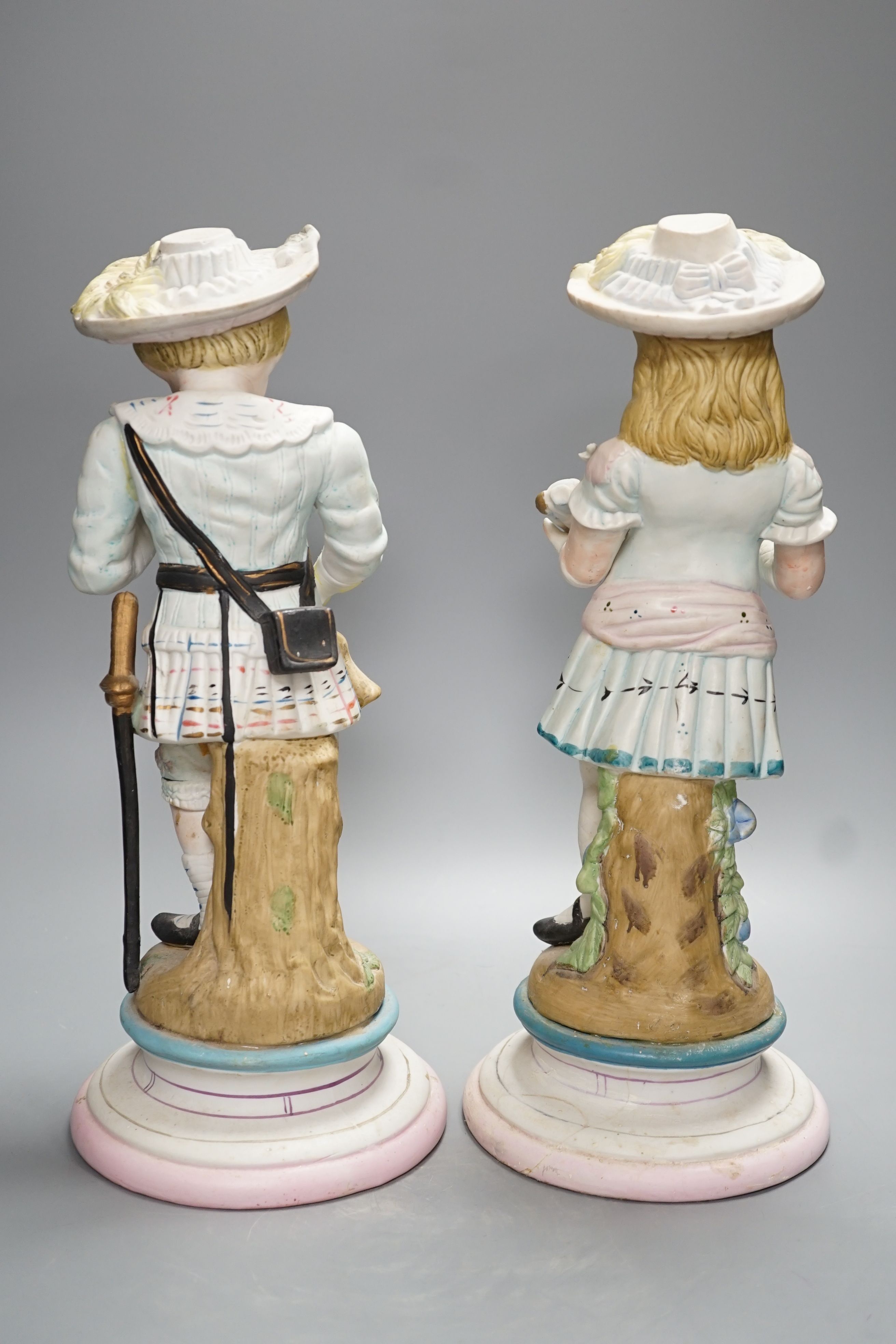 A pair of Continental coloured bisque figures of children - 39cm high